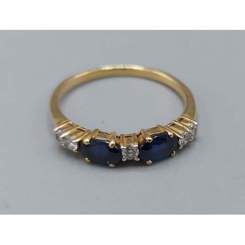 211 - An 18ct gold Sapphire and Diamond band ring set with two Sapphire and five Diamonds, 2.8gms, ring si... 