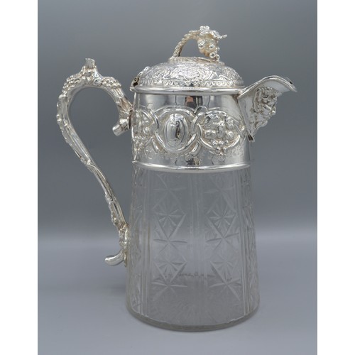 212 - A silver plated and cut glass claret jug decorated with grape vine and figural spout, 26cms tall