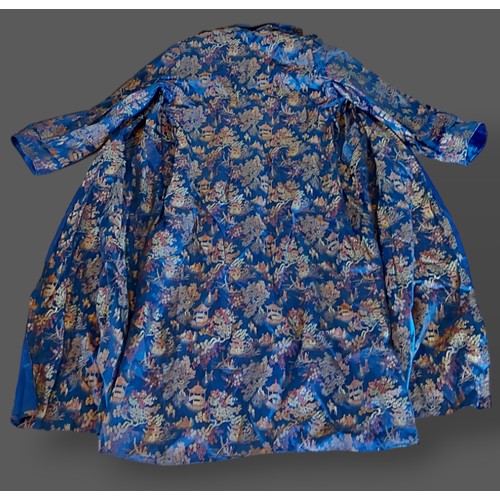 270 - A Chinese Kimono embroidered with figures amongst foliage with blue ground