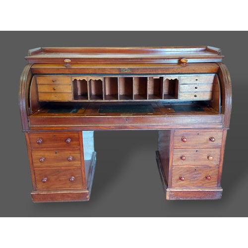 347 - A Victorian mahogany twin pedestal cylinder desk, the fitted top above six drawers with knob handles... 