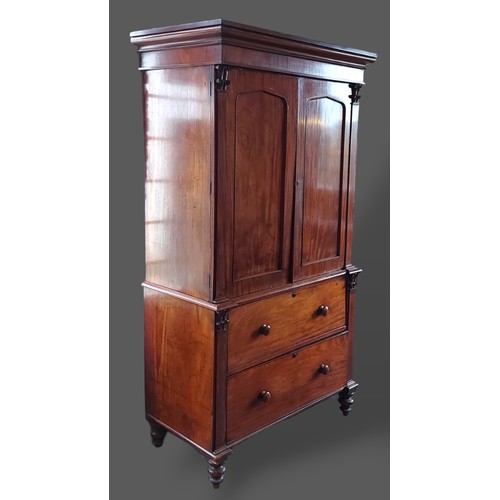 359 - A William IV mahogany press cupboard, the moulded cornice above two panel doors enclosing shelves, t... 