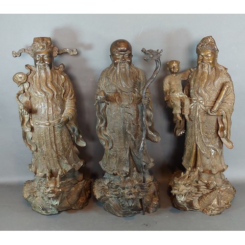 224 - A group of three Chinese patinated bronze figures, Sanxing Divine Immortals, 51cms tall