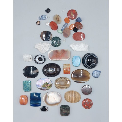 279 - A small oval enamel plaque, lake scene together with a collection of polished stones