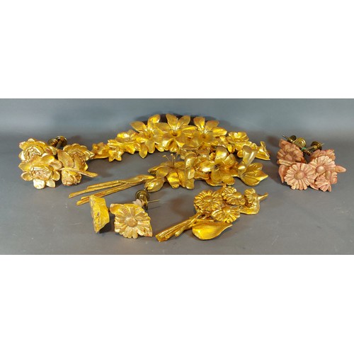 289 - A group of three gilded carvings of foliate form together with a collection of similar curtain tie b... 