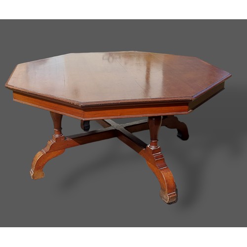 380 - An Edwardian large centre table of octagonal form, the moulded top above four turned legs with stret... 