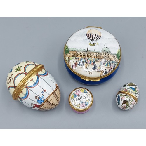296 - A Halcyon Days Enamel box together with another similar smaller box and two enamel decorated eggs