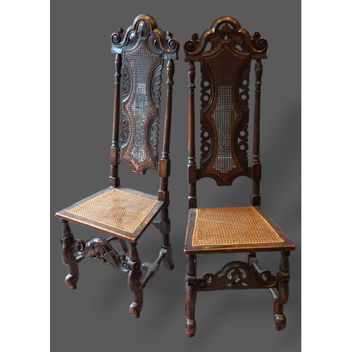 401 - A pair of 19th Century oak Jacobean style side chairs, each with a carved cane back above a similar ... 