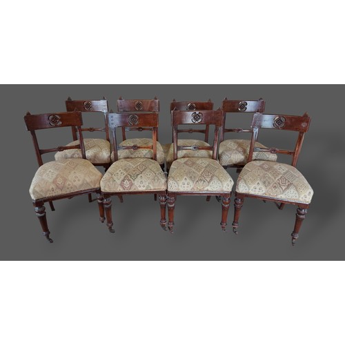 441 - A set of eight Arts and Crafts dining chairs, each with a pierced carved rail back above a stuffover... 