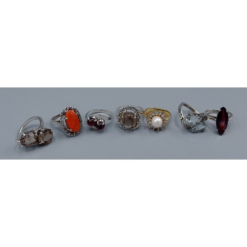 116 - A collection of seven dress rings set with various stones