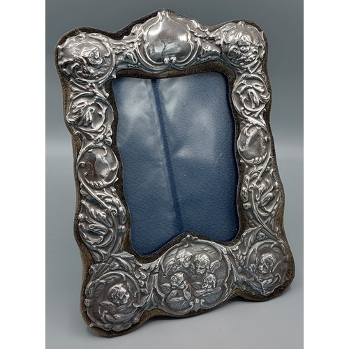 118 - A London silver photograph frame decorated Whispers, 22cms x 16cms