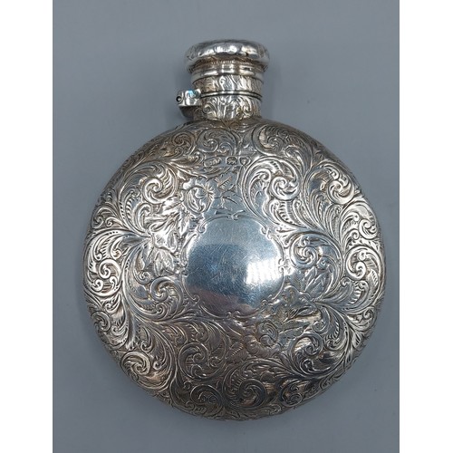 124 - A Victorian silver hip flask of circular engraved form, London 1887, makers mark rubbed, 5ozs, 9.5cm... 