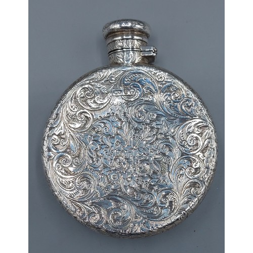 124 - A Victorian silver hip flask of circular engraved form, London 1887, makers mark rubbed, 5ozs, 9.5cm... 