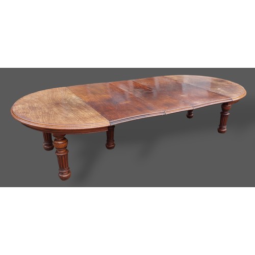 393 - A 19th Century Pollard oak dining table by Gillow and Co. the moulded top above a plain frieze raise... 