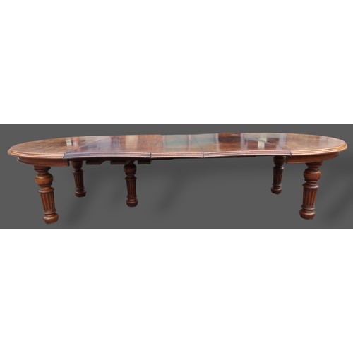 393 - A 19th Century Pollard oak dining table by Gillow and Co. the moulded top above a plain frieze raise... 