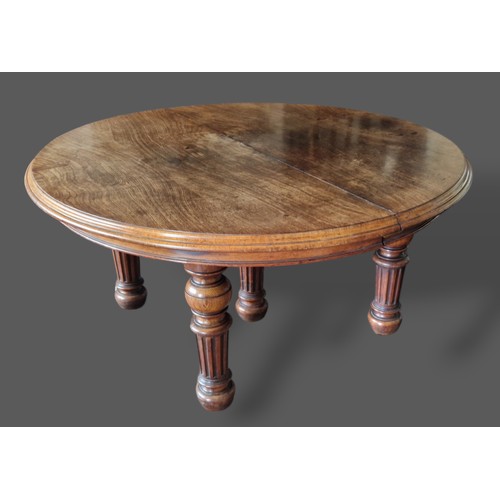 393 - A 19th Century Pollard oak dining table by Gillow and Co. the moulded top above a plain frieze raise... 