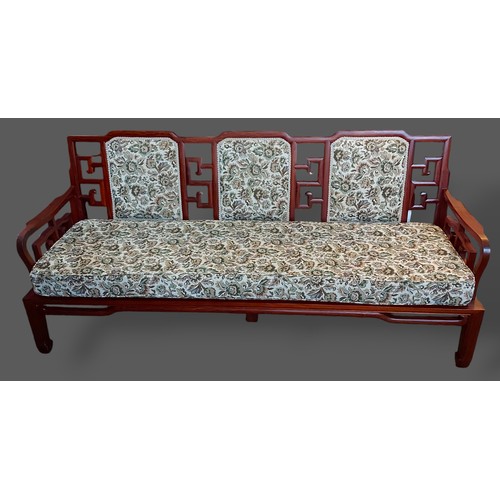 396 - A Chinese hardwood sofa with a triple back and pierced arms raised upon square legs, 190cms long