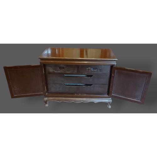 399 - A Chinese hardwood low side cabinet with two lacquered doors enclosing drawers upon low feet, 90cms ... 