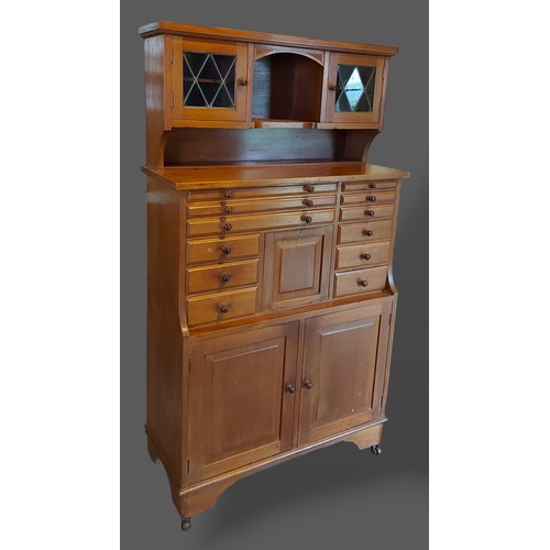 400 - An early 20th Century mahogany Dentists cabinet with two lead glazed doors above a central cupboard ... 