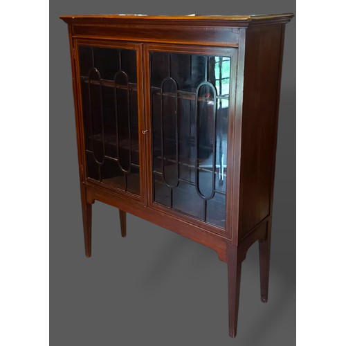 402 - An Edwardian mahogany display cabinet with two astragal glazed doors raised upon square tapering leg... 