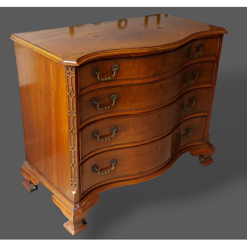 415 - A late 19th Century mahogany Serpentine chest, the moulded top above four drawers with brass handles... 