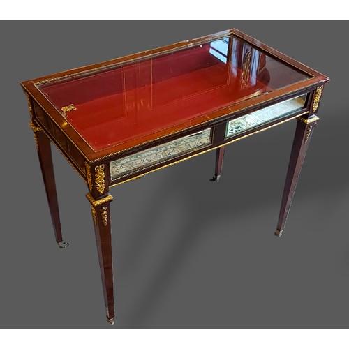 416 - A French gilt metal mounted Bijouterie, the glazed hinged top enclosing a baize lined interior above... 