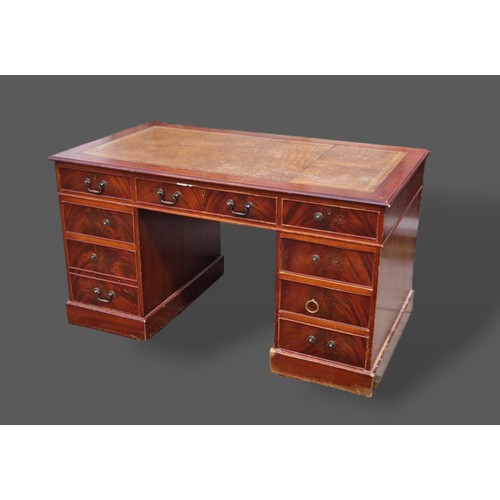 417 - A mahogany twin pedestal desk, the tooled leather inset top above eight drawers with plinth bases, 1... 