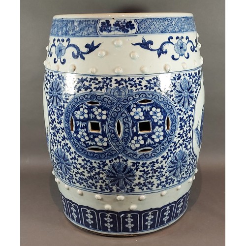 10 - A Chinese garden seat of barrell form decorated in underglaze blue with reserves depicting figures, ... 