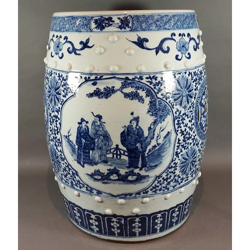 10 - A Chinese garden seat of barrell form decorated in underglaze blue with reserves depicting figures, ... 