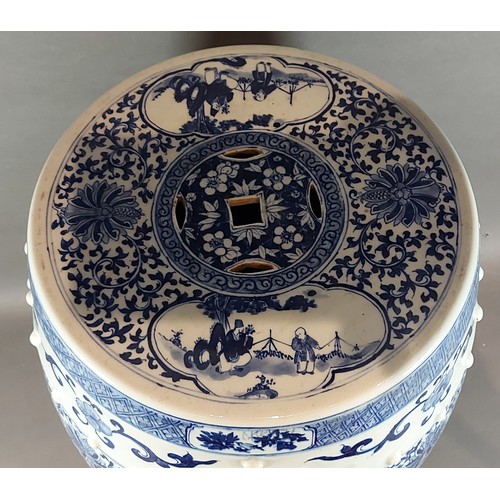 10 - A Chinese garden seat of barrell form decorated in underglaze blue with reserves depicting figures, ... 