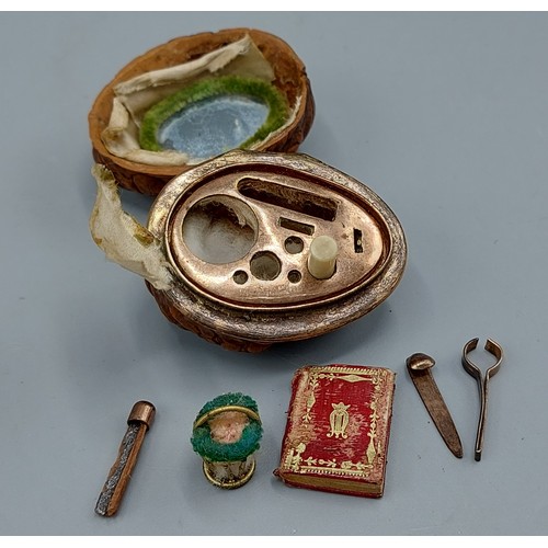 277 - A 19th Century Etui made from a walnut shell the interior with various implements