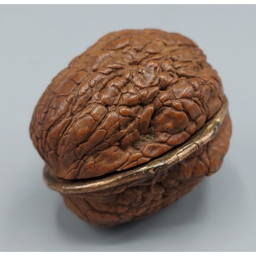 277 - A 19th Century Etui made from a walnut shell the interior with various implements