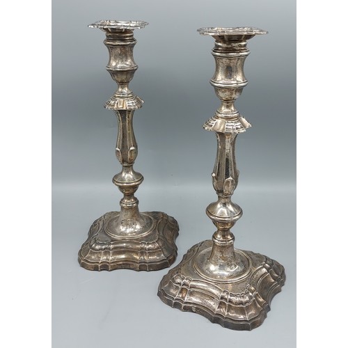 278 - A pair of Edwardian silver candlesticks in Georgian style with shaped stepped bases, Sheffield 1909,... 