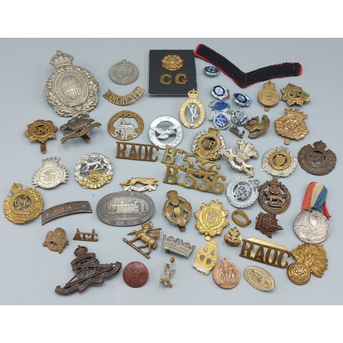 361 - A collection of military cap badges, medals and related items