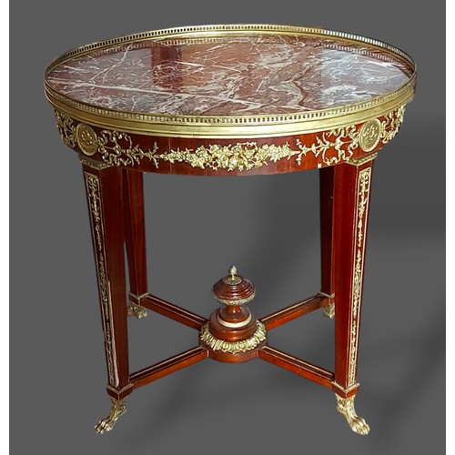 465 - A french oval centre table the marble top with brass gallery above a gilt metal mounted frieze with ... 