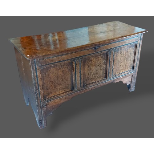 469 - A George III oak coffer, the hinged top above a three panel front, 118cms wide, 46cms deep and 67cms... 