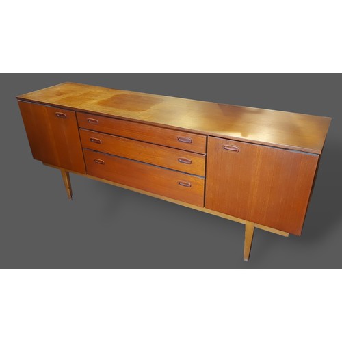 203 - A 1906's teak sideboard with three central drawers flanked by cupboard doors raised upon tapering le... 