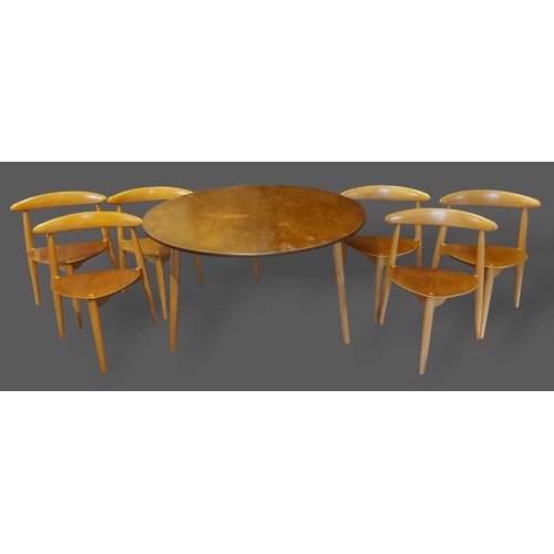 202 - Hans Wegner for Fritz Hansen, a Danish dining suite comprising a set of six chairs, each with a rail... 