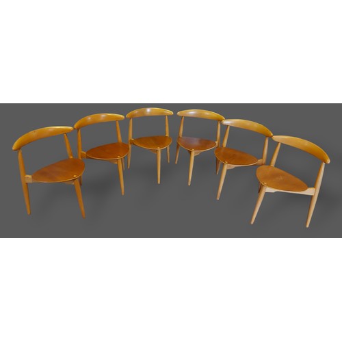 202 - Hans Wegner for Fritz Hansen, a Danish dining suite comprising a set of six chairs, each with a rail... 