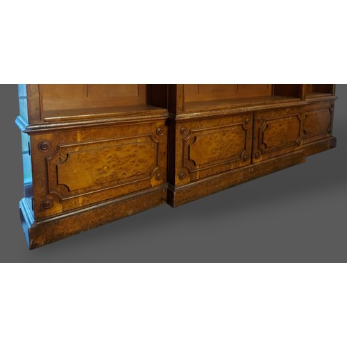 219 - A 19th Century burr oak breakfront bookcase, the moulded cornice above open shelves with four doors ... 