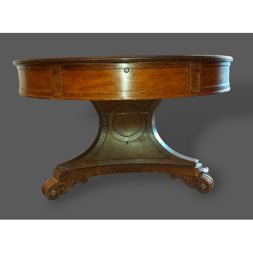 220 - A William IV oak drum centre table, the top with one frieze drawer above a triangular centre column ... 