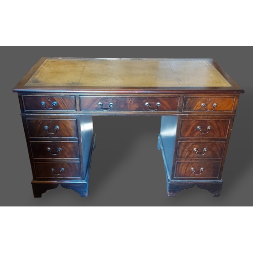 227 - A 20th Century twin pedestal desk, the tooled leather inset top above nine drawers raised upon brack... 