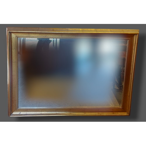 229 - A rectangular gilt framed wall mirror, 115cms x 145cms