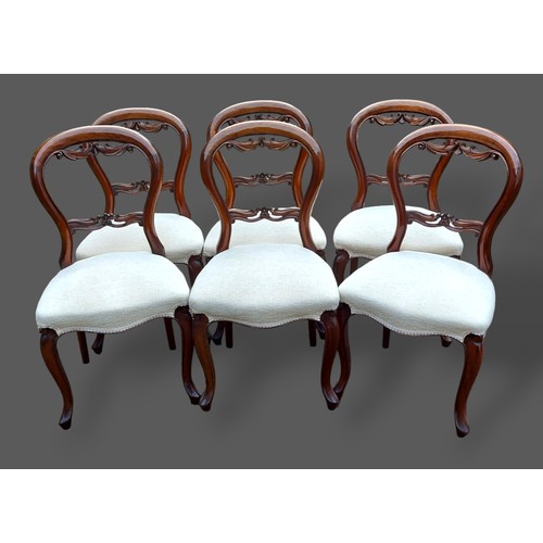 236 - A set of six Victorian mahogany dining chairs, each with a pierced carved back with stuffover seat r... 