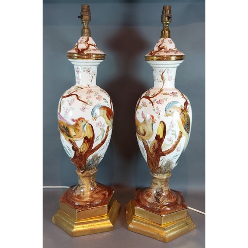 26 - A pair of large table lamps, each decorated with birds amongst foliage, 68cms tall