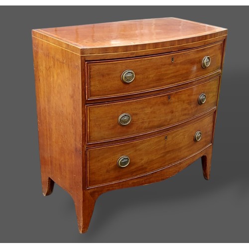 261 - A 19th Century mahogany bow fronted chest, the satinwood crossbanded top above three drawers with ci... 