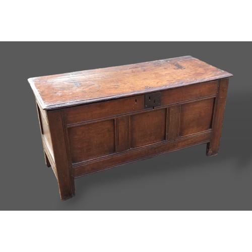 264 - A George III oak coffer, the hinged top above a three panel front flanked by stiles, 116cms wide, 47... 