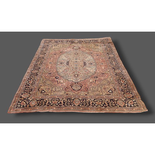 197 - A Kerman carpet with a central medallion within an all-over design upon a cream and blue ground with... 