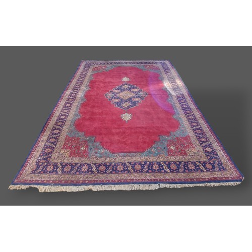 198 - A North West Persian woollen carpet, with central medallion upon a red and blue ground within multip... 