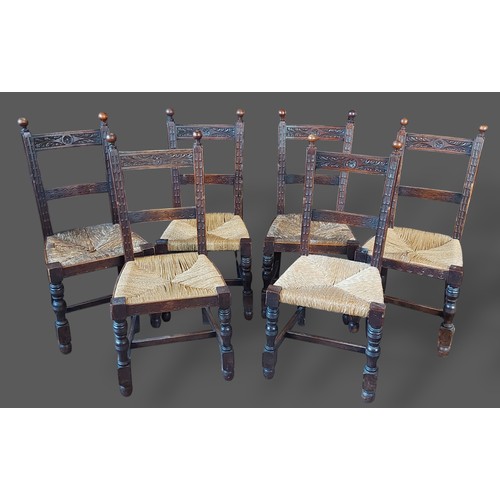 269 - A set of six Victorian carved oak dining chairs, each with a carved rail back above a strung seat ra... 