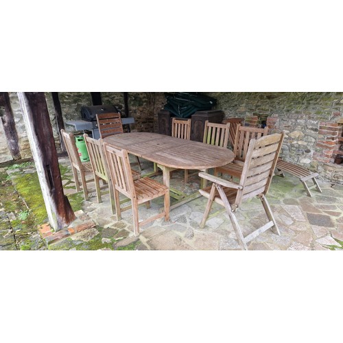 300 - A teak garden table and eight chairs together with a similar reclining chair